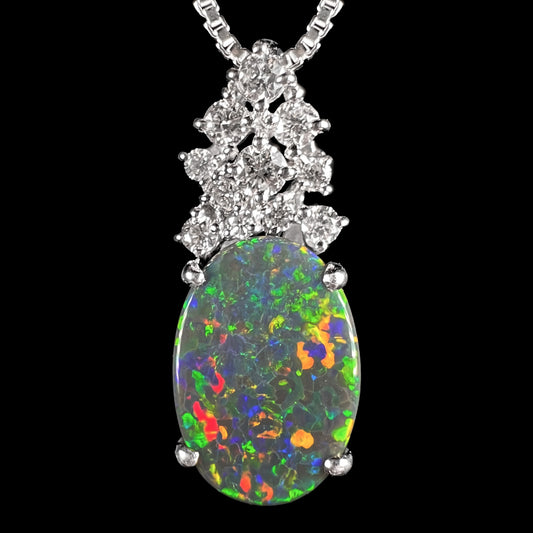 Close-up of a Japanese platinum pineapple pendant with a 2.65ct Australian black opal, red-orange multicolor play-of-color, and diamond crown.