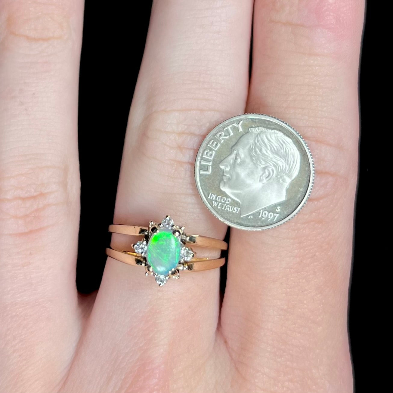 Reversible green Australian opal and diamond flip ring worn on hand next to US dime coin for scale