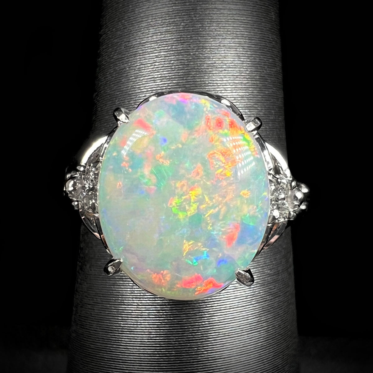 Close-up of a vintage Japanese platinum ring with a 2.36ct Australian light opal showing warm red-orange play-of-color.