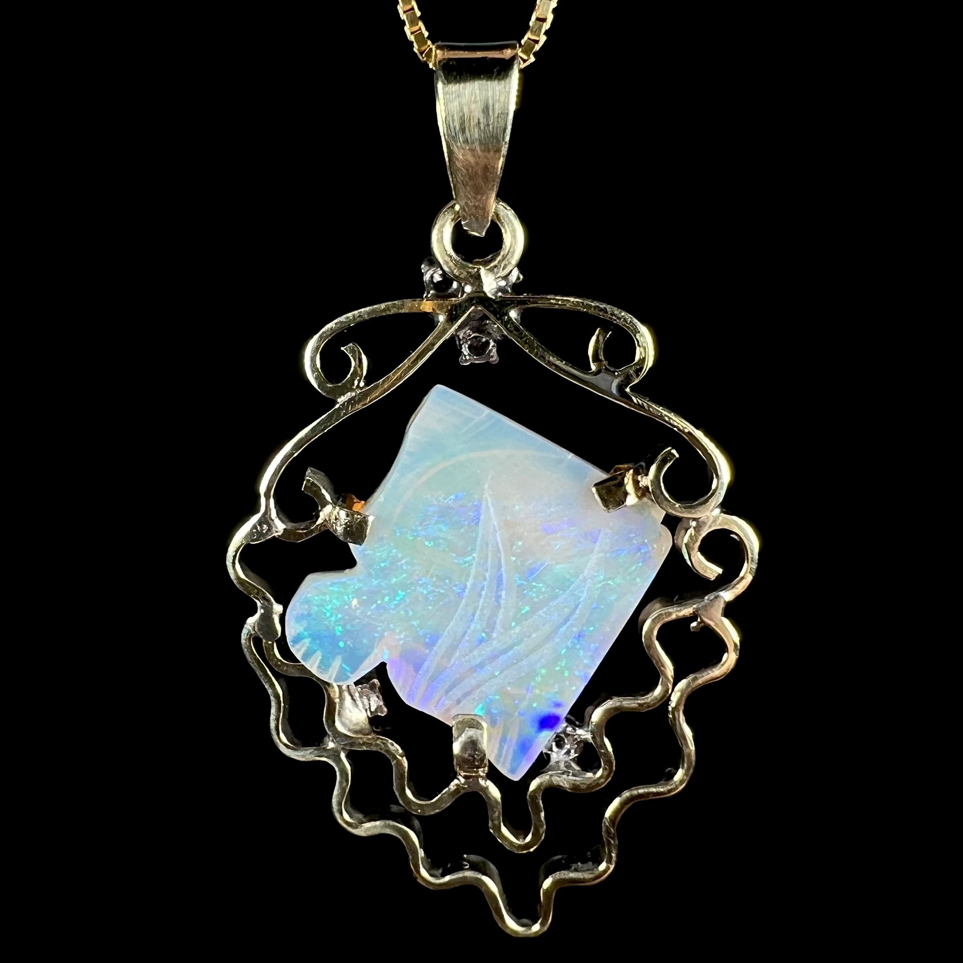 Back side of Australian opal fish carving pendant in 14k gold with aquatic motif