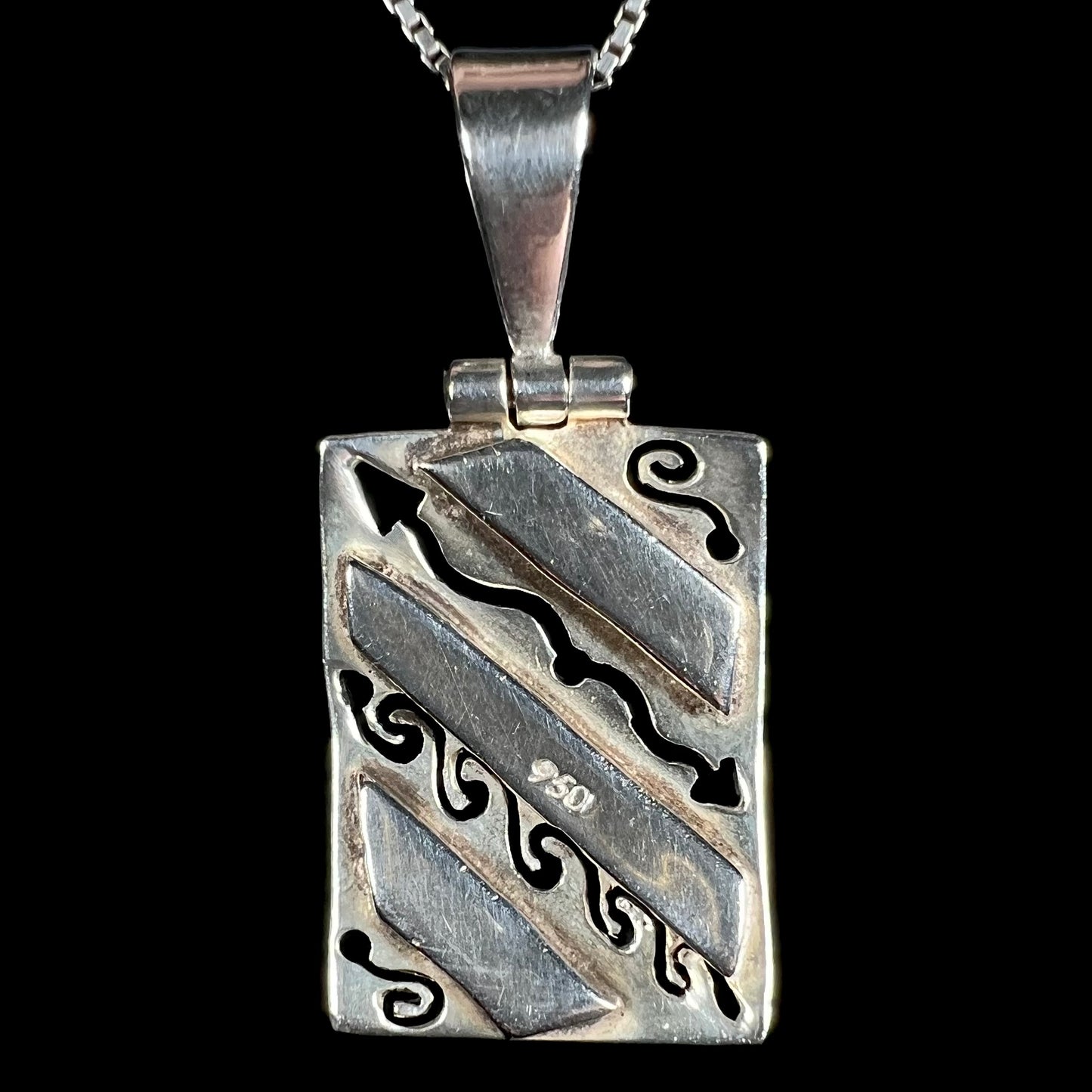 Back of a .950 silver men's pendant, shown against a black background.