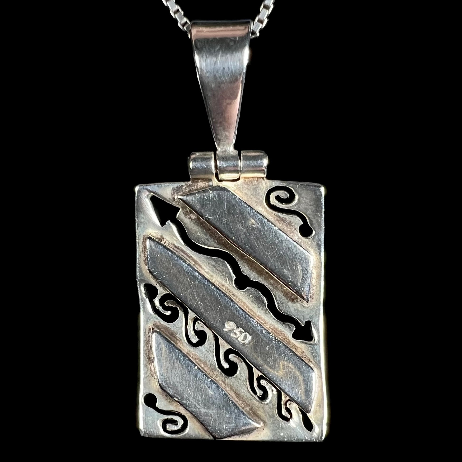 Back of a .950 silver men's pendant, shown against a black background.