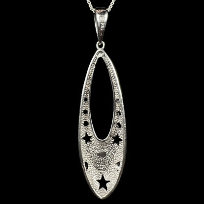Back side of a sterling silver ballerina shoe pendant, shown against a black background.