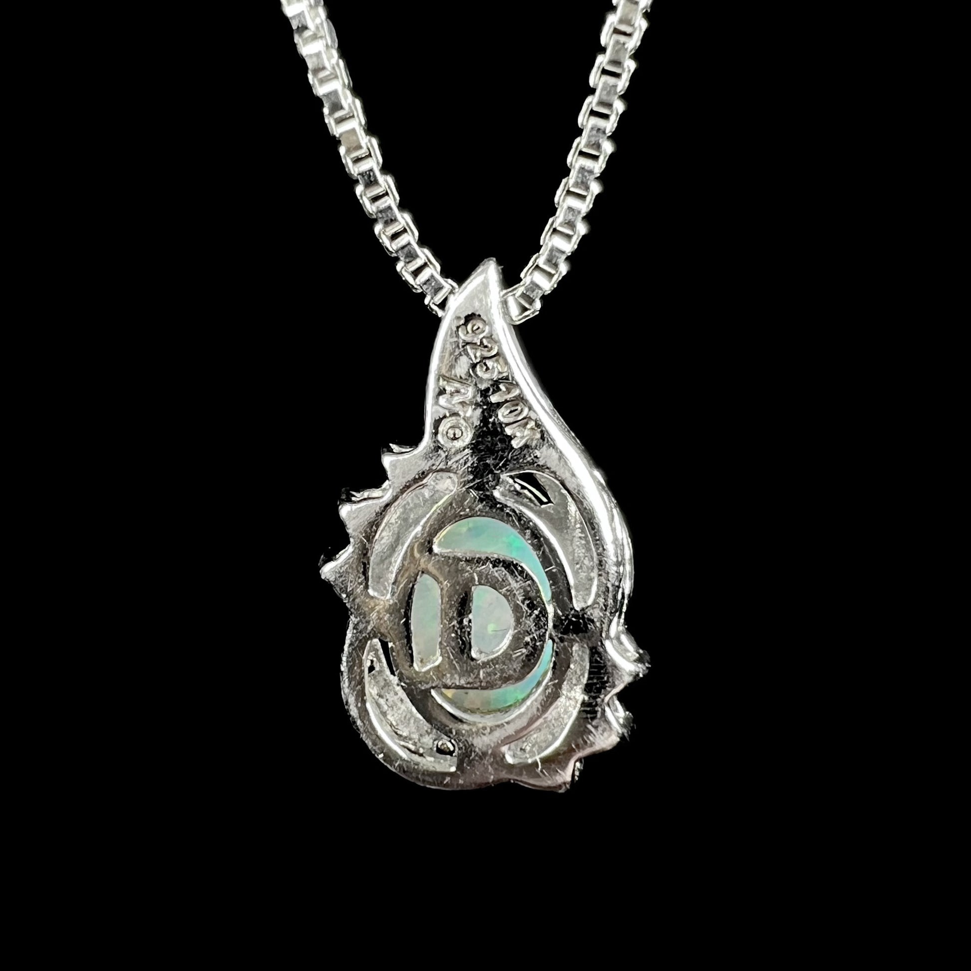 The back side of a sterling silver pendant by Alwand Vahan.  The letter "D" is built into the design.