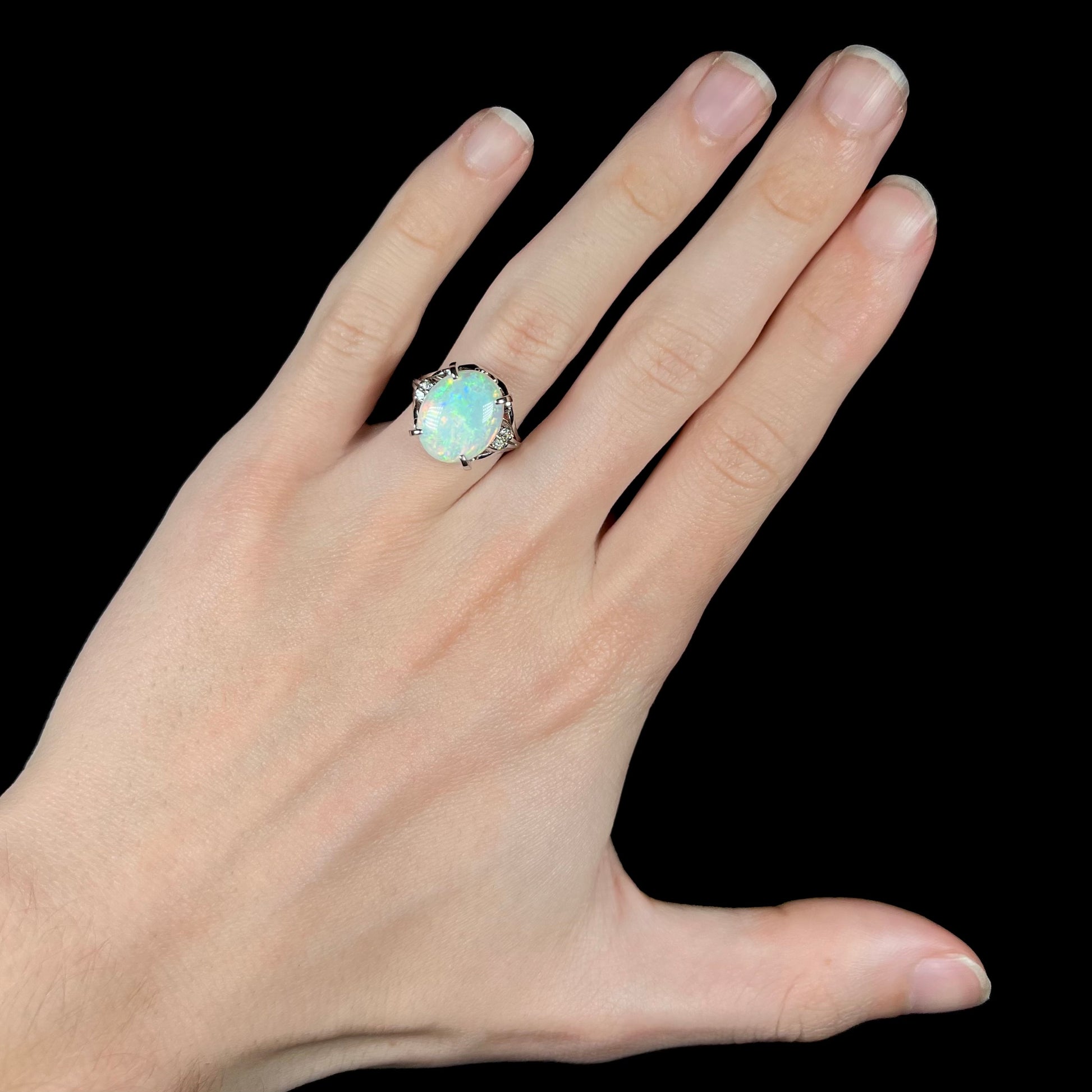 A platinum opal engagement ring set with a big, 4.83ct Australian opal and diamond accents.