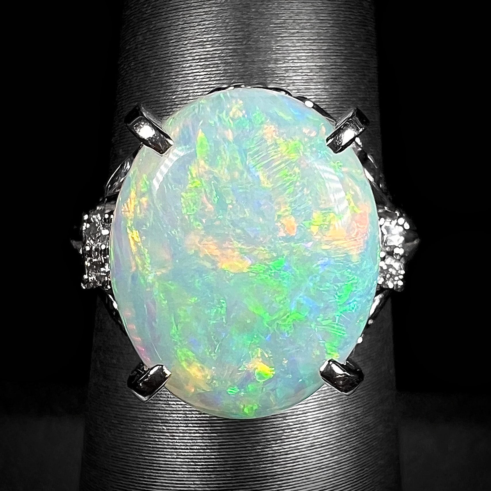 A big opal engagement ring set with a 4.83ct Coober Pedy opal with diamond accents in platinum.