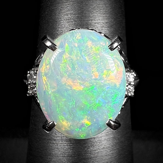 A big opal engagement ring set with a 4.83ct Coober Pedy opal with diamond accents in platinum.