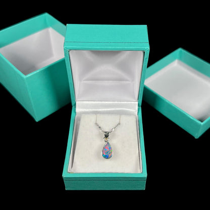 A pear shaped black opal necklace set in sterling silver.  The opal vividly flashes every color of the rainbow.
