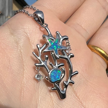 A silver plated coral reef necklace with blue lab-created opal inlay and CZ accents.