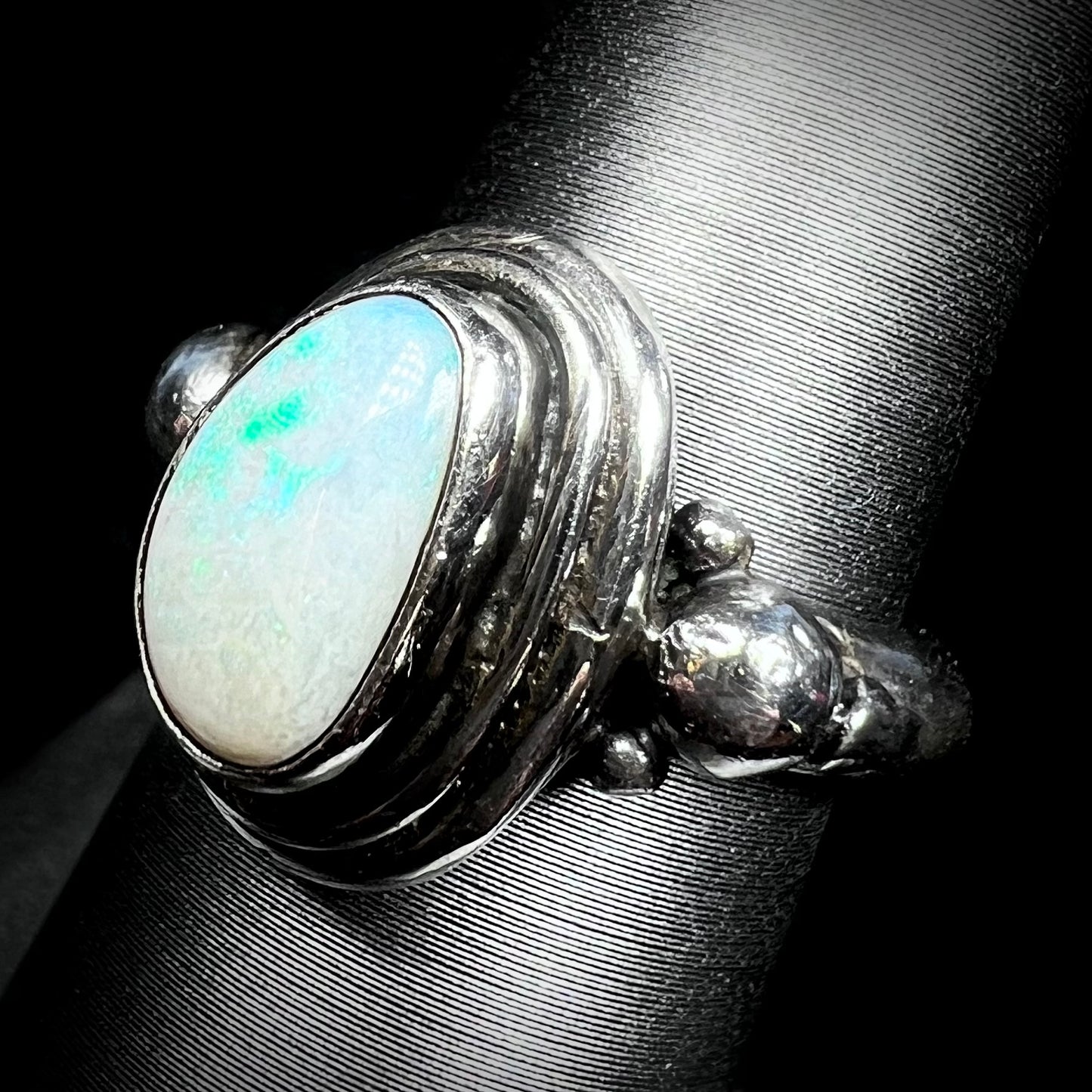 Angled view of a handmade Boho-style sterling silver opal ring set with an Australian opal.