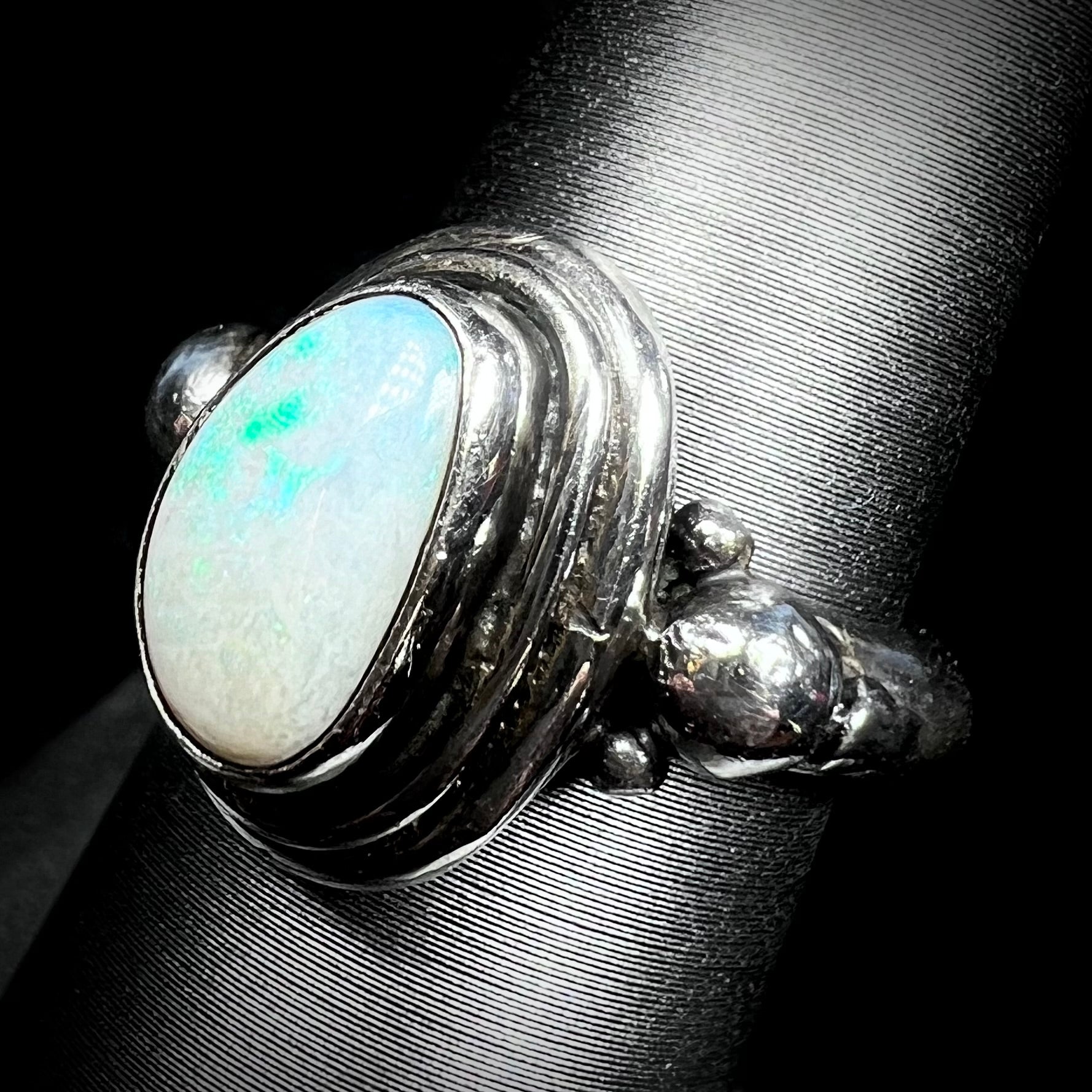Angled view of a handmade Boho-style sterling silver opal ring set with an Australian opal.