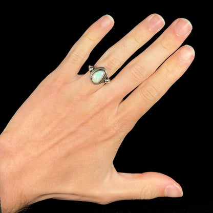 A handmade Boho-style sterling silver opal ring set with an Australian opal, worn on a hand.