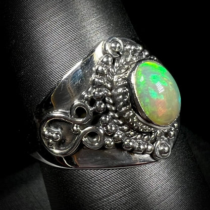 A sterling silver, boho-style opal ring, shown from an angle.