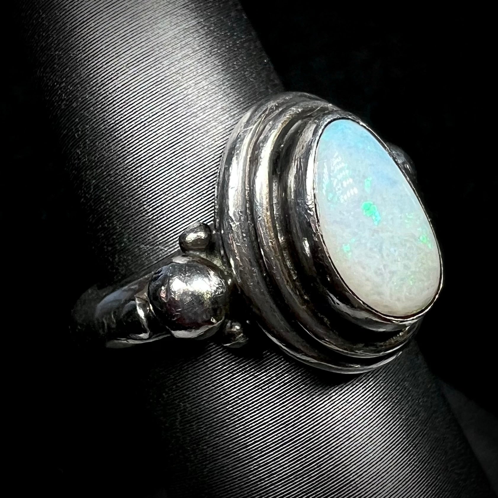 A handmade Boho-style sterling silver opal ring set with an Australian opal shown from an angle.