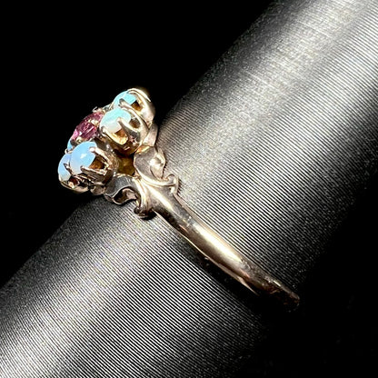 Side shank view of British 9k gold Victorian opal ring on ring display