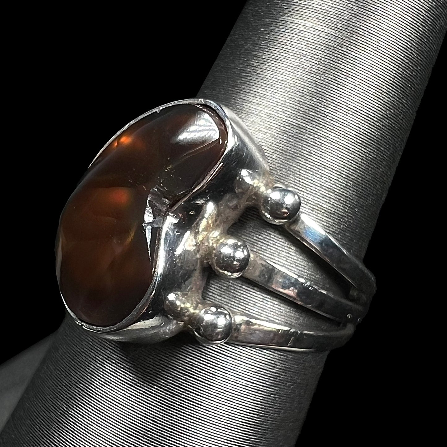 Side-angled view of a brown fire agate ring showing split shank design.