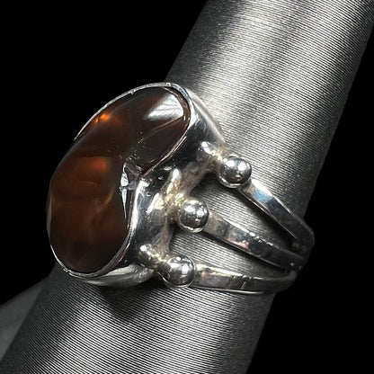 Side-angled view of a brown fire agate ring showing split shank design.