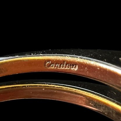 Close-up of "Cardow" hallmark stamp inside reversible gold opal ring's shank, denoting Cardow Jewelers