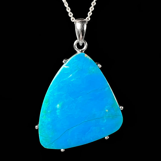  blue opal necklace in sterling silver displayed against a black background.