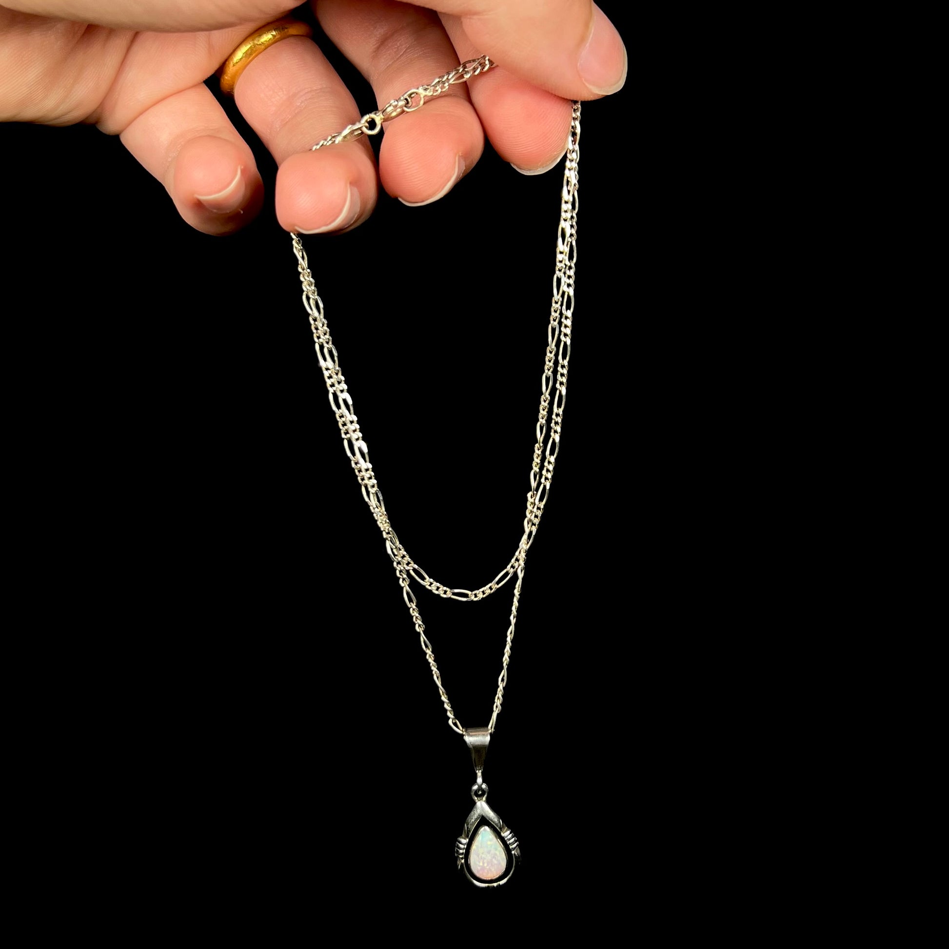 A pear shaped sterling silver Navajo pendant set with a green Australian opal made by artist, Chris Charley.