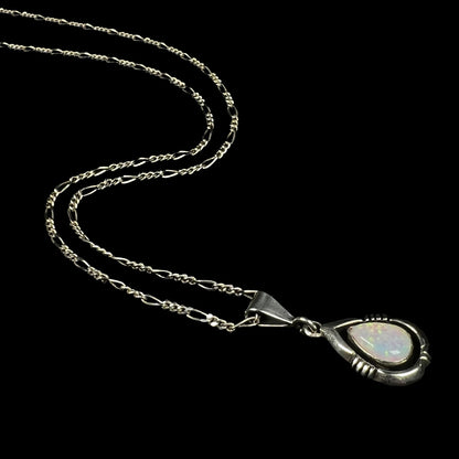 A pear shaped sterling silver Navajo pendant set with a green Australian opal made by artist, Chris Charley.