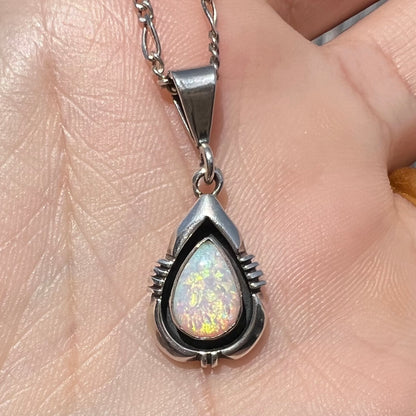 A pear shaped sterling silver Navajo pendant set with a green Australian opal made by artist, Chris Charley.