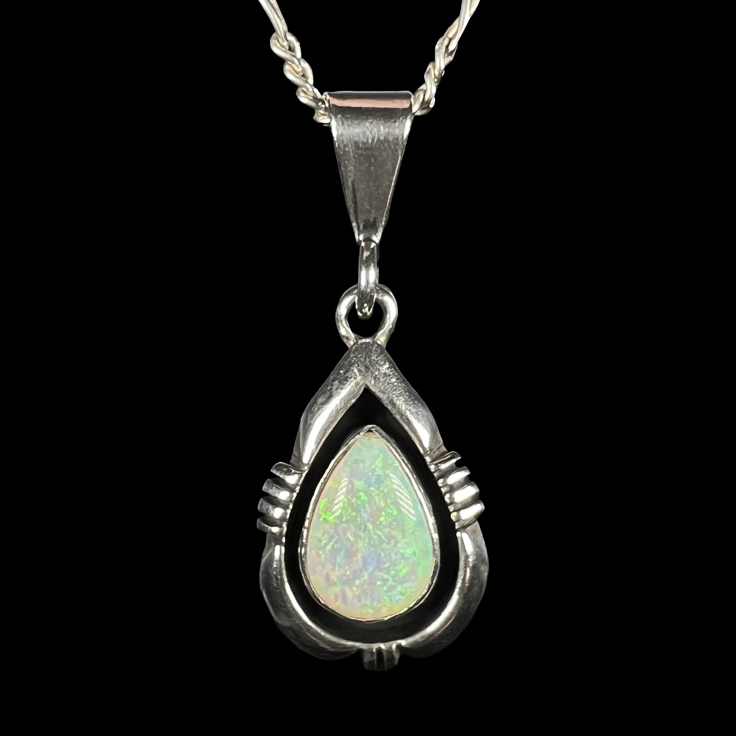 A pear shaped sterling silver Navajo pendant set with a green Australian opal made by artist, Chris Charley.