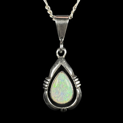 A pear shaped sterling silver Navajo pendant set with a green Australian opal made by artist, Chris Charley.