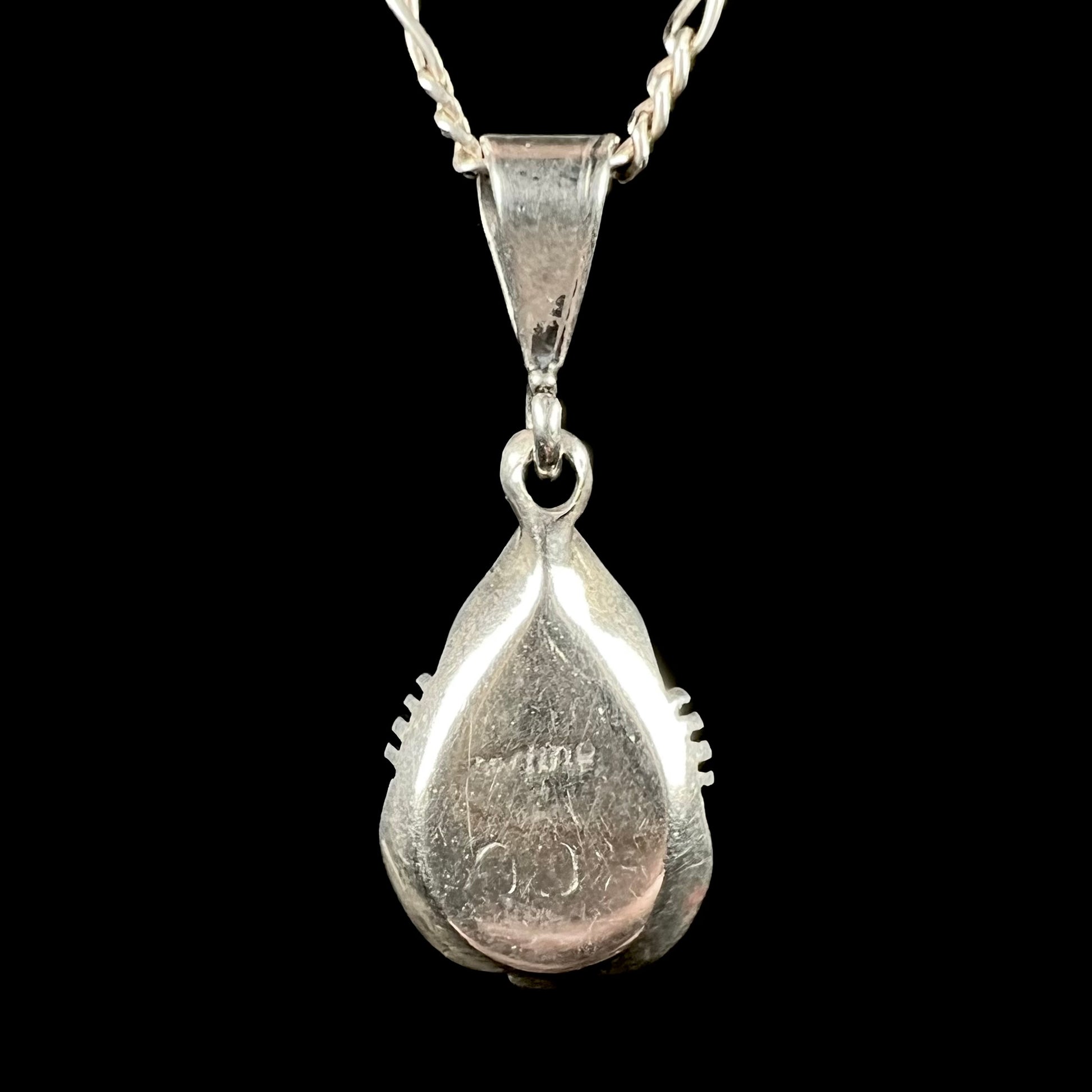 Back of a sterling silver Navajo pendant signed "CC Sterling" by artist, Chris Charley.