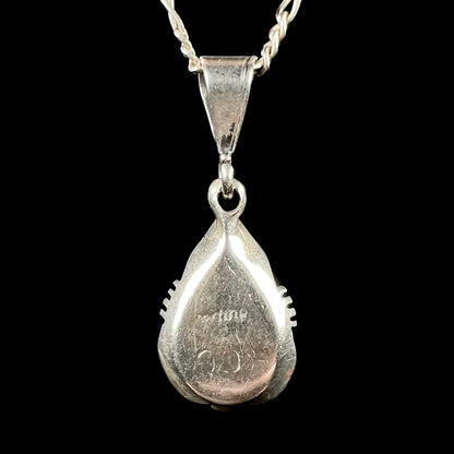 Back of a sterling silver Navajo pendant signed "CC Sterling" by artist, Chris Charley.