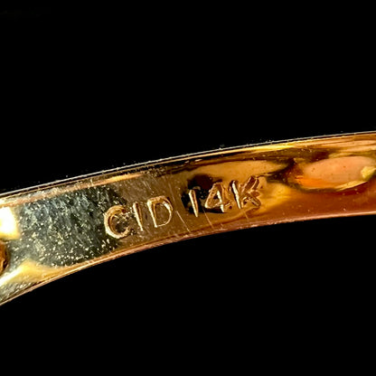Close-up of inside of a vintage gold ring's shank stamped, "CID" and "14K", denoting New York manufacturer, Clyde Duneier Inc.