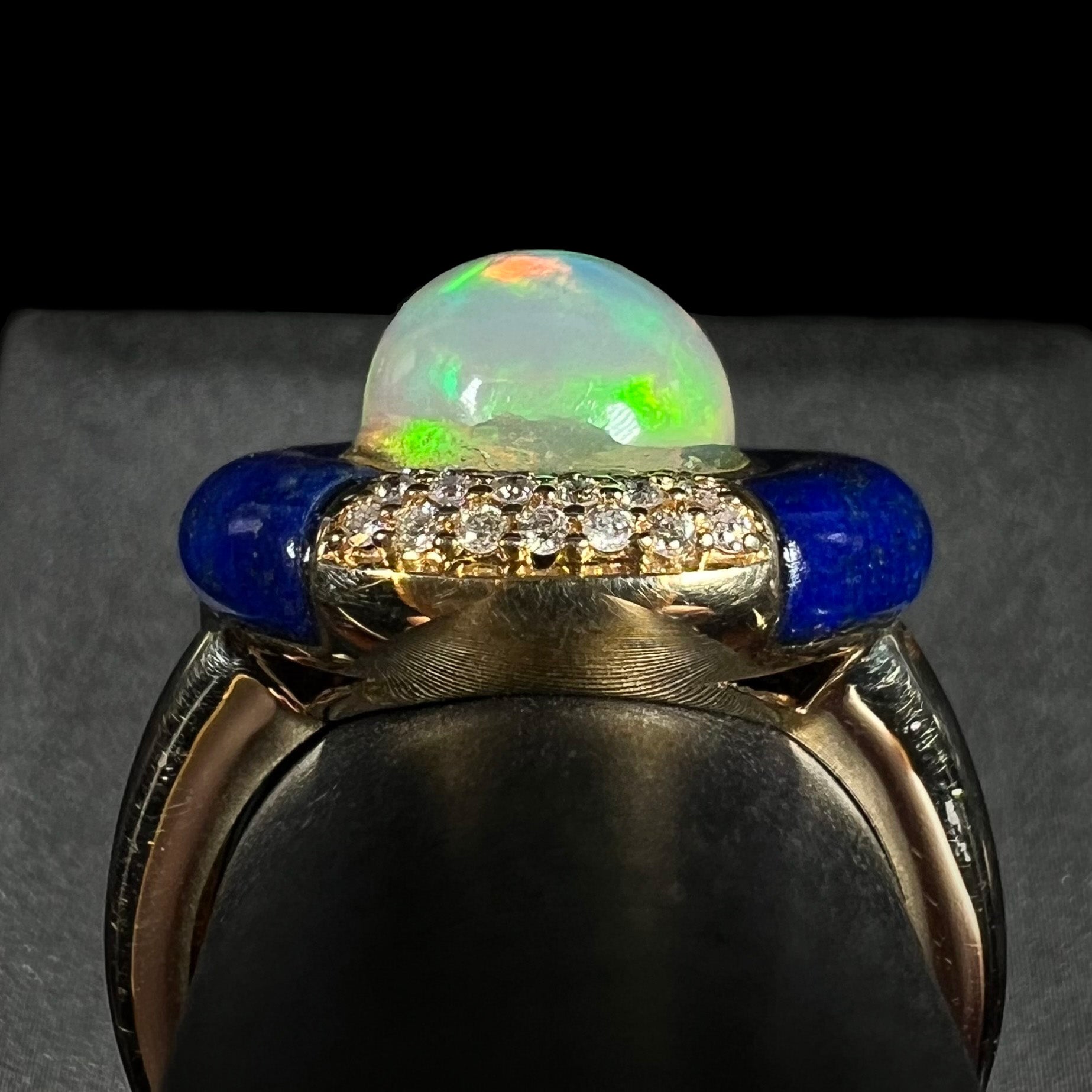 Close-up side profile gallery view of a designer women's Ethiopian opal, diamond, and lapis lazuli ring in 14k gold by Cirari Jewels.