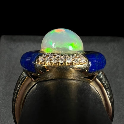 Close-up side profile gallery view of a designer women's Ethiopian opal, diamond, and lapis lazuli ring in 14k gold by Cirari Jewels.