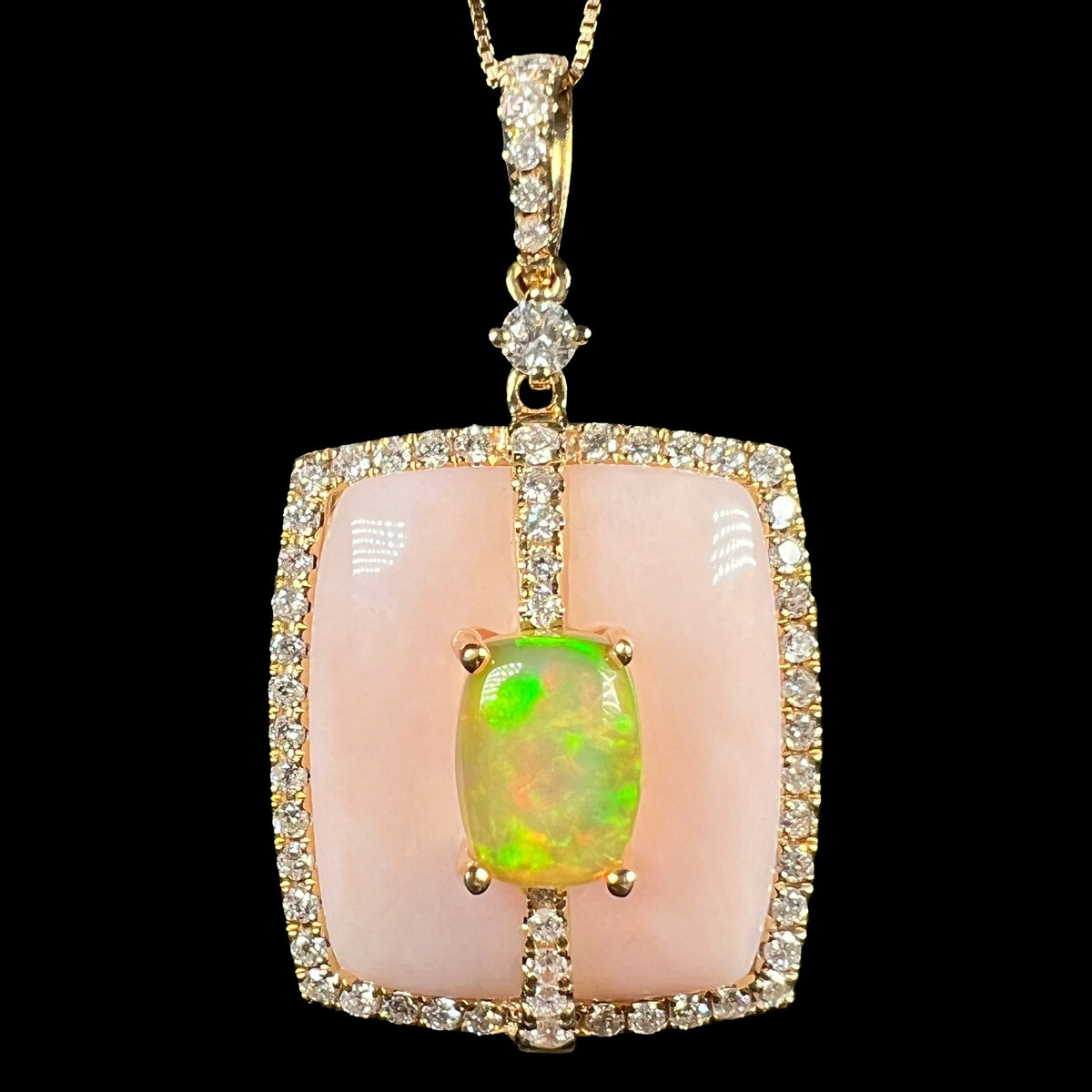 Close-up of Cirari brand women's 14k gold Ethiopian opal, Peruvian pink opal, and diamond halo necklace, shown against a black background.