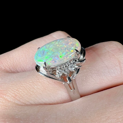 A platinum ring set with a 2.54ct Coober Pedy semi-crystal opal and diamond accents.