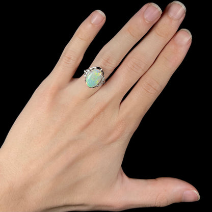 A platinum ring set with a 2.54ct Coober Pedy semi-crystal opal and diamond accents.