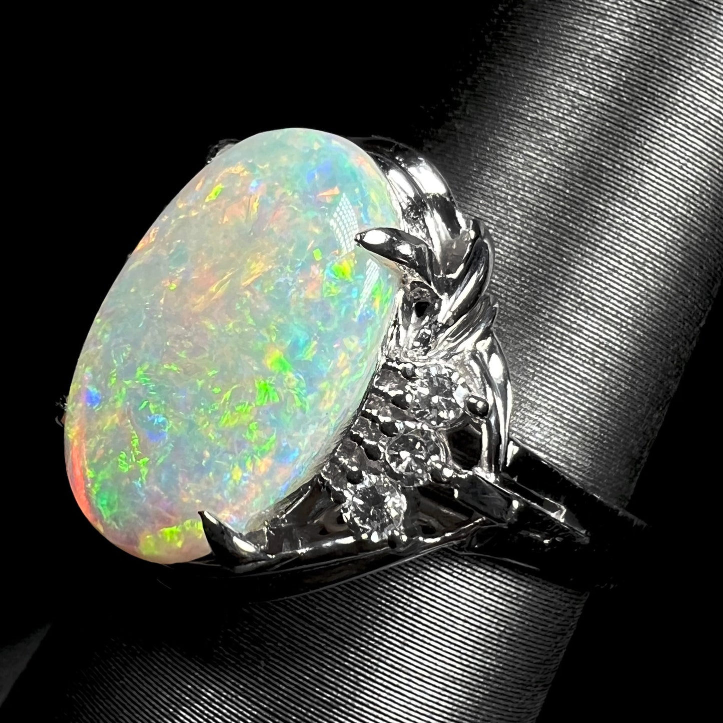 A platinum ring set with a 2.54ct Coober Pedy semi-crystal opal and diamond accents.