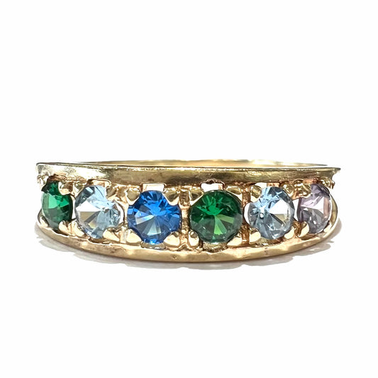 A ladies' yellow gold band set with green, dark blue, light blue, and light purple stones.