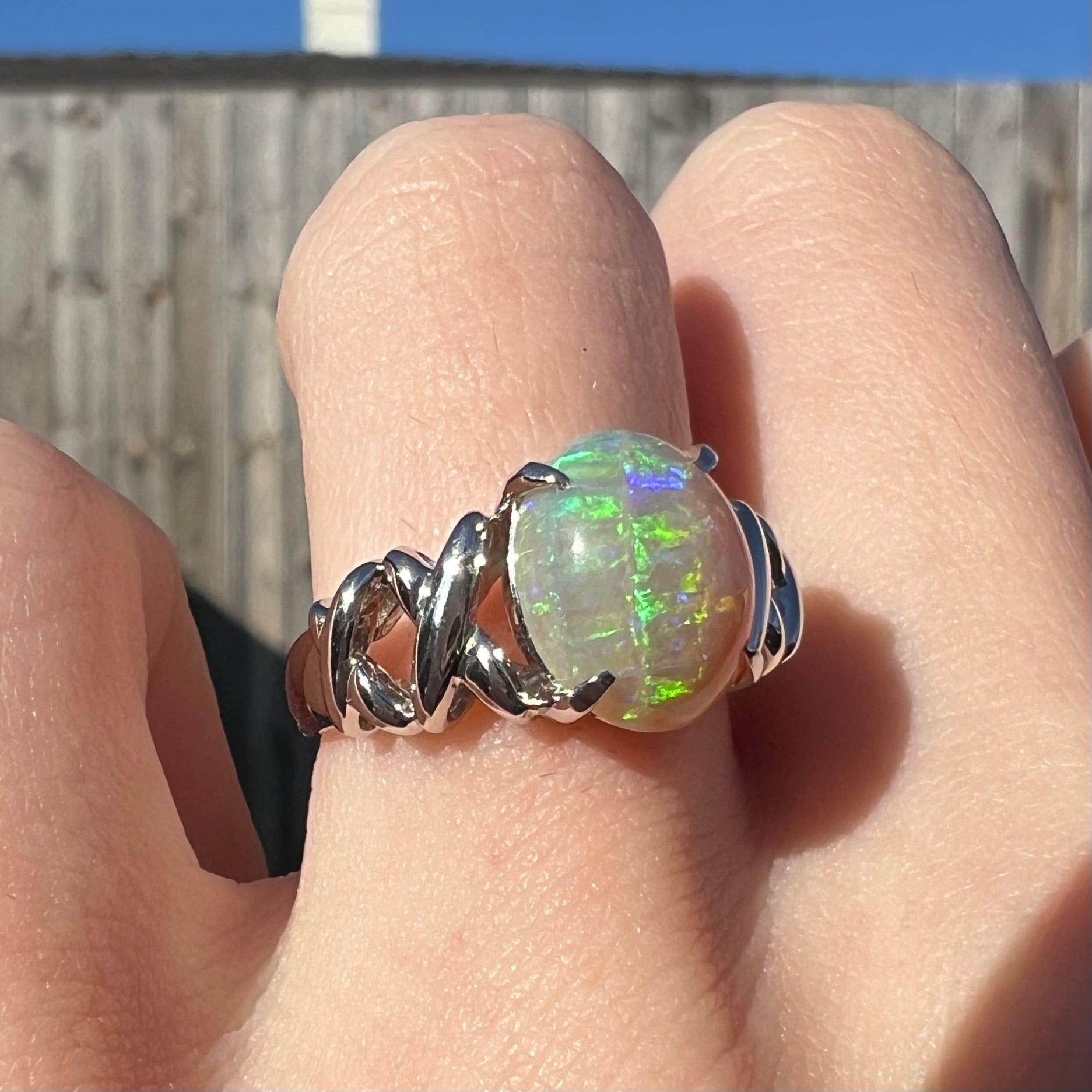 A platinum crisscross ring mounted with a 2.20ct Coober Pedy opal.