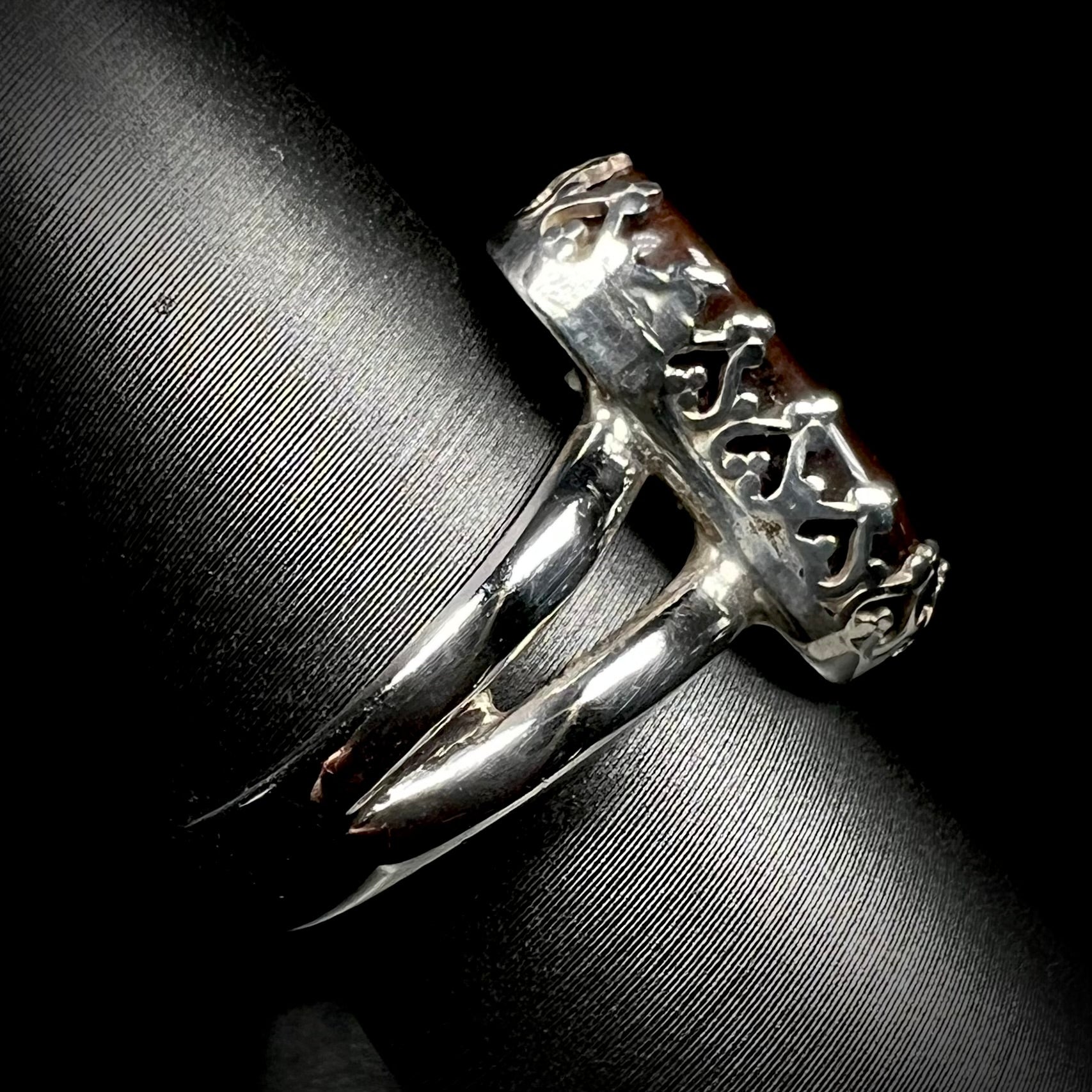 Side view of crown-design ring made from sterling silver with a split shank.  The shank is in focus.
