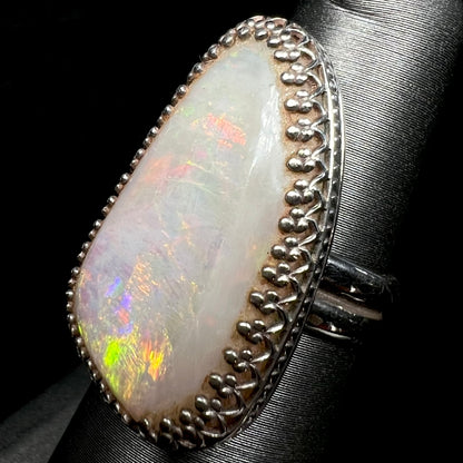 A crown-design sterling silver opal cocktail ring shown from an angle close-up on a ring display.