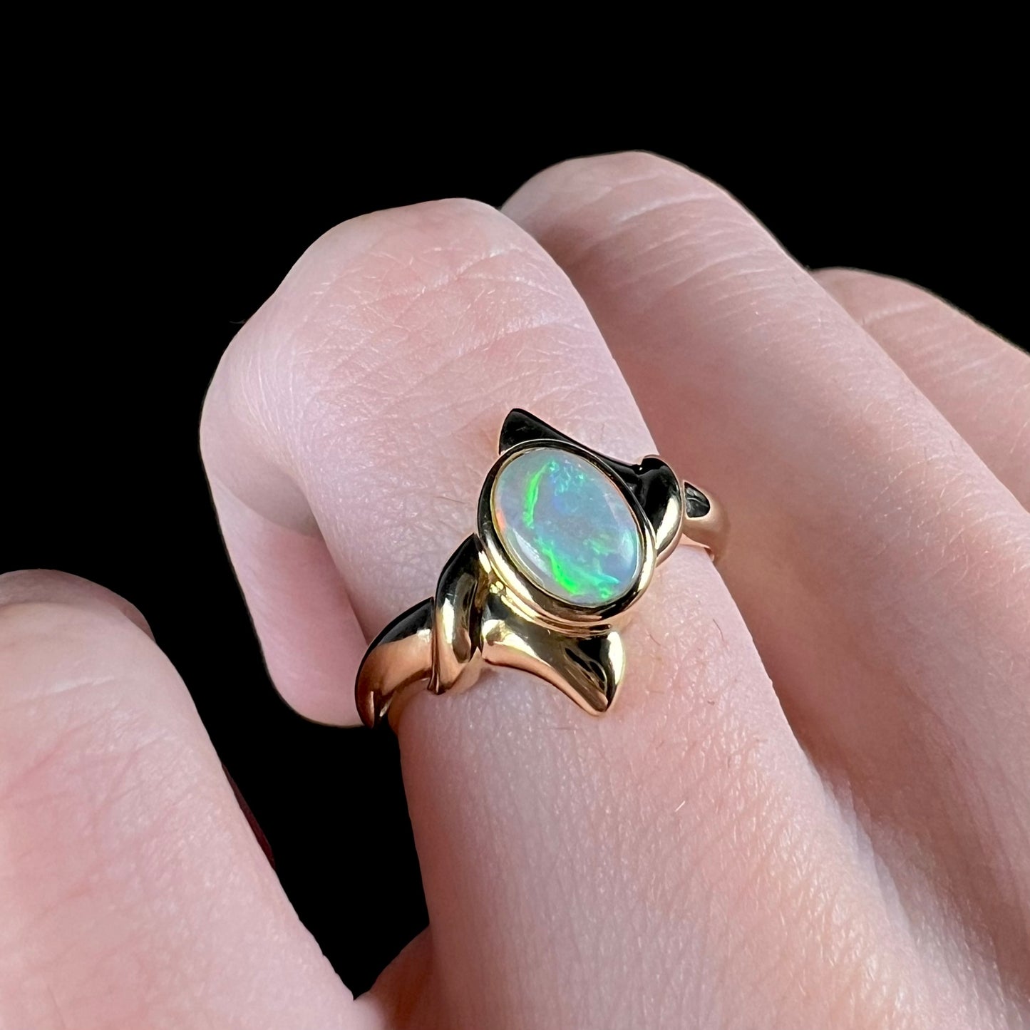 A Lightning Ridge crystal opal engagement ring set in 18 karat yellow gold.