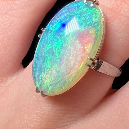 A crystal opal ring photographed up close, displaying a natural fissure inclusion in the opal.