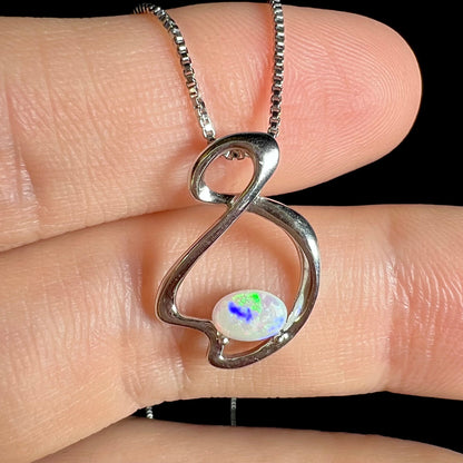A ladies' sterling silver necklace set with an oval cabochon cut natural white crystal opal with green fire.