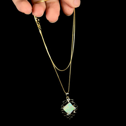 Custom-made fish pendant carved from opal set with diamonds in 14k gold, dangled from chain by hand