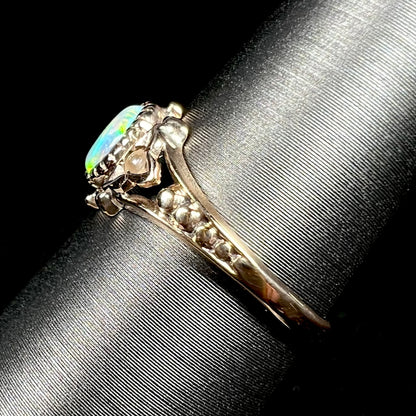 Side view of dainty, delicate 9k yellow gold shank on Victorian era opal ring, shown on ring display