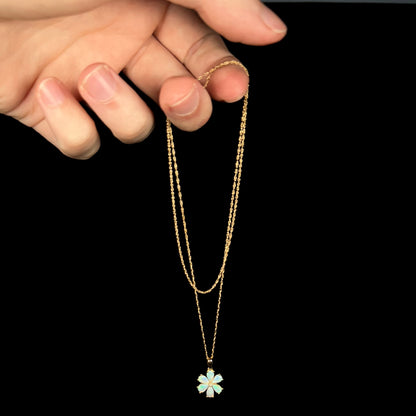 Delicate gold opal flower design necklace dangled from chain by hand
