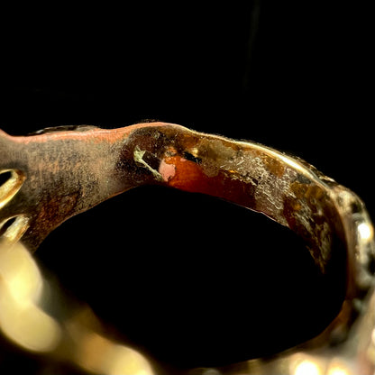 Macro view of inside of estate gold-plated costume ring's shank.  Wear is visible where the gold plating has worn through.