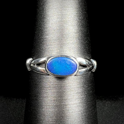 Close-up of refurbished estate women's sterling silver opal doublet ring on display