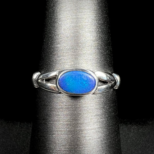 Close-up of refurbished estate women's sterling silver opal doublet ring on display